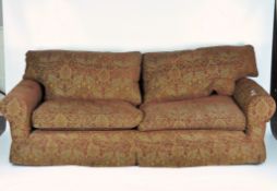 A Multiyork four seater sofa, with red floral upholstery and gilt detailing,