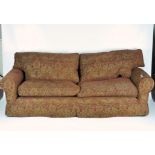 A Multiyork four seater sofa, with red floral upholstery and gilt detailing,