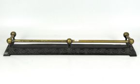 An Edwardian brass and cast metal fire curb,
