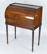 A French style mahogany cylinder bureau, with bands of kingood inlay over a frieze drawer,