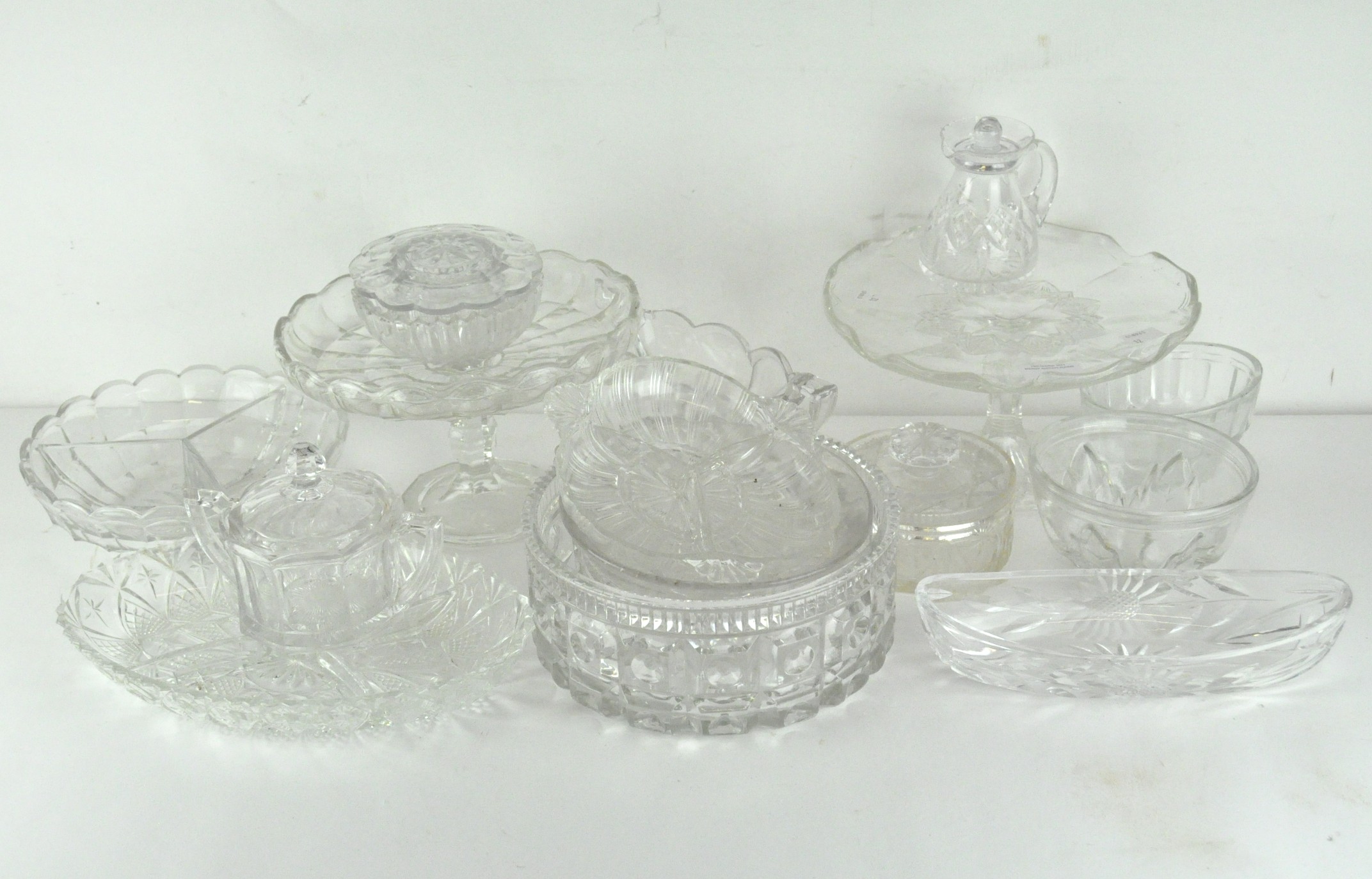 A large selection of glassware, comprising mostly press moulded glassware, including jelly moulds,