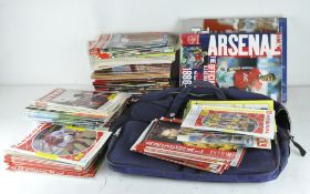 A collection of assorted football programmes and cassettes, most relating to Arsenal,