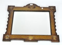 A moulded oak framed wall mirror, with bevelled edge,