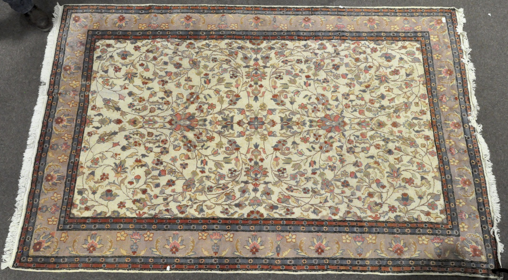 A large 20th century Chinese style carpet with a pink ground border of lotus flowers