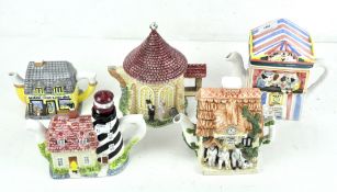 Five ceramic cottage teapots, including a church, General Store.