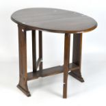 A 20th century folding table with fluted side supports,