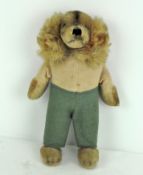 A rare 1950's Steiff Waldili Hunter dog, wearing green trousers, with yellow label and metal button,