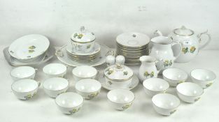 A Danish Bing & Grondahl tea service, decorated with yellow flowers on a white ground, gilt rims,