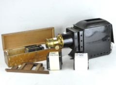 An early 20th century Optimus Magic lantern, black painted case with brass detailing, 45cm long,