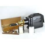 An early 20th century Optimus Magic lantern, black painted case with brass detailing, 45cm long,