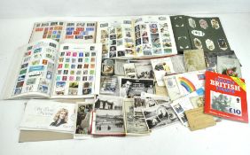 A collection of stamp albums, cigarette cards and post cards including first day lovers,