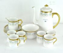 A six piece Shelley coffee set, decorated with gilt Greek key pattern border over a shell motif,