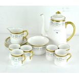 A six piece Shelley coffee set, decorated with gilt Greek key pattern border over a shell motif,