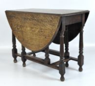 A late 19th century Oak gateleg table, raised upon turned supports,