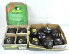 Seven Thomas Taylor lawn bowls, together with a boxed set of Herselite lawn bowls