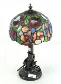 A contemporary table lamp with stained glass Tiffany style lamp shade,