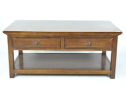 A contemporary mahogany veneer coffee table of rectangular form,