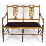 A 20th century hallway bench, the wooden frame with pierced back, on turned supports,