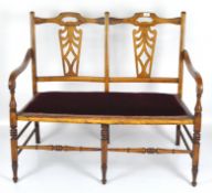 A 20th century hallway bench, the wooden frame with pierced back, on turned supports,