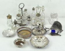 A selection of silver plate and glassware, including cruets, coasters and candlestick