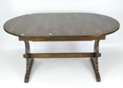 A modern oak dining table of extending form,