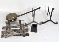 A vintage brass bed pan, a fire grate and a pair of fire dogs