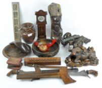 A selection of carved wooden items to include two Balinese kris swords,