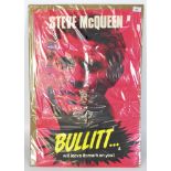 A large movie poster for the film Bullitt, starring Steve McQueen,