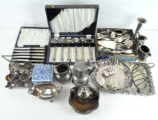 A quantity of vintage silver plate including a boxed set of knives, one of soup spoons, jugs,