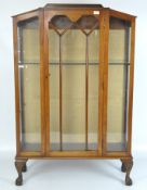 An Art Deco style mahogany glazed display cabinet, raised upon four claw & ball feet,