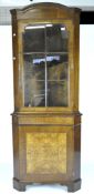 A mahogany corner cupboard with arch pediment top over an astragal glazed door raised on a base