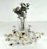 A collection of decorative floral posy vases,