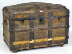 A late 19th/early 20th century dome topped wooden travelling trunk,