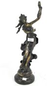 A vintage bronze lamp in the form of a lady with windswept hair and dress, holding the torch aloft,