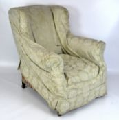 A Victorian wing back armchair, with floral upholsterey,