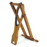 A Tom Hill (Knightsbridge) horse riding boot remover, with pierced oak frame, bearing ivorine label,