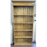 A modern pine open bookcase, with four shelves,