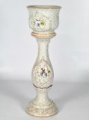 A Capodimonte style jardiniere and baluster stand with moulded lattice work style decoration