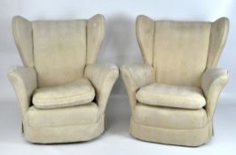 A pair of vintage cream fabric upholstered armchairs,