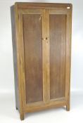 An early 20th century wardrobe, two door, opening to reveal partially fitted interior,
