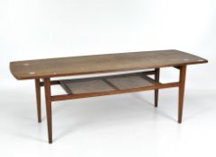 A 1960's teak coffee table with caned lower shelf, on tapering legs,