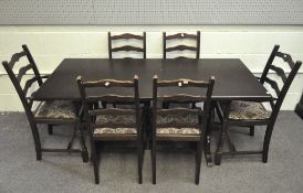 A modern dark stained dining table and six chairs with tapestry style upholstery,