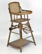 A late Victorian/Edwardian metamorphic children's high chair, with cane seat and back,
