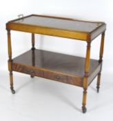 A rectangular mahogany two tier buffet with lift off tray top set with brass handles,