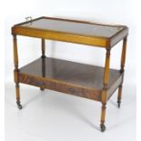 A rectangular mahogany two tier buffet with lift off tray top set with brass handles,