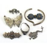 A collection of sterling silver and white metal jewellery items, including brooches,