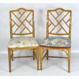 A pair of caned simulated bamboo chairs, the seats upholstered,