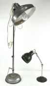 A vintage floor lamp with metal shade, together with a green enamel adjustable table lamp,