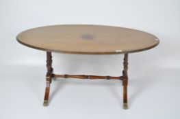 A mahogany Georgian style oval coffee table with inlaid details,