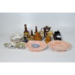 A collection of 20th century ceramics, to include three Bells whiskey decanters, stoneware mugs,